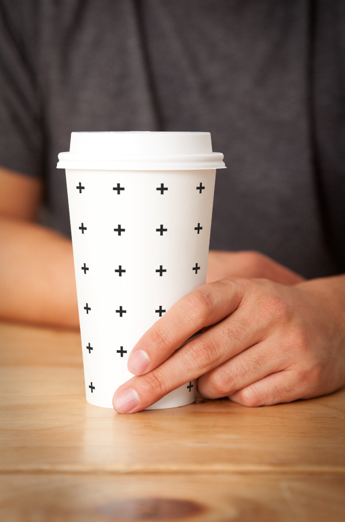 Cup 0527 — Held, on table mockup surface