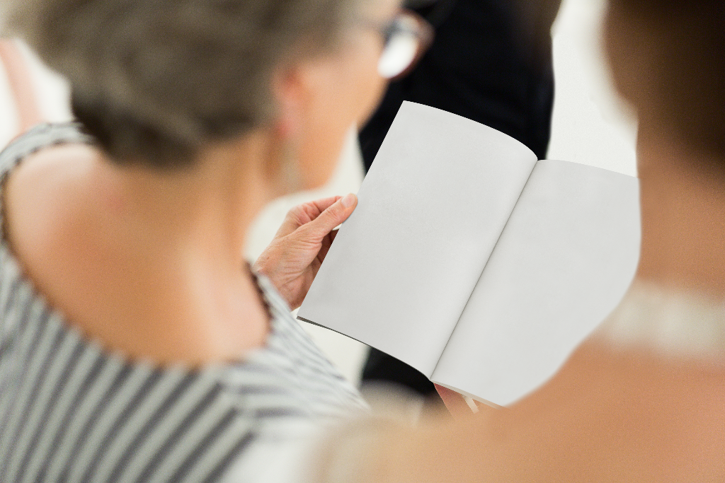 Book 2115 — Open, held mockup surface