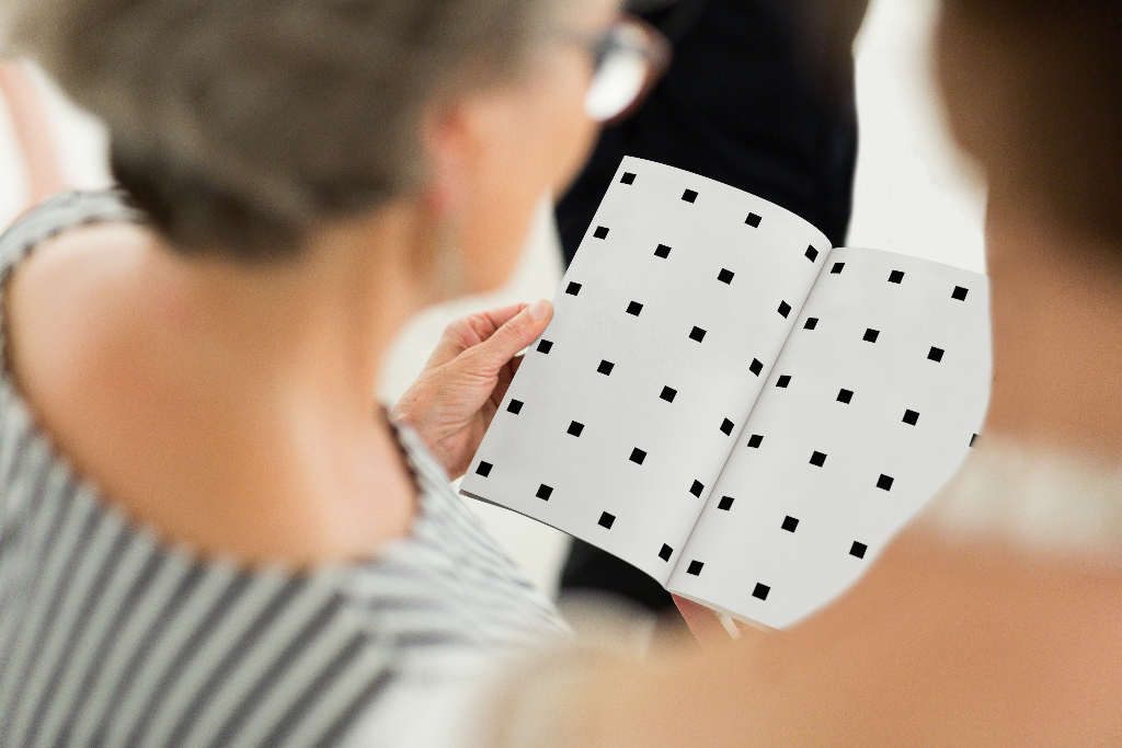 Book 2115 — Open, held mockup surface