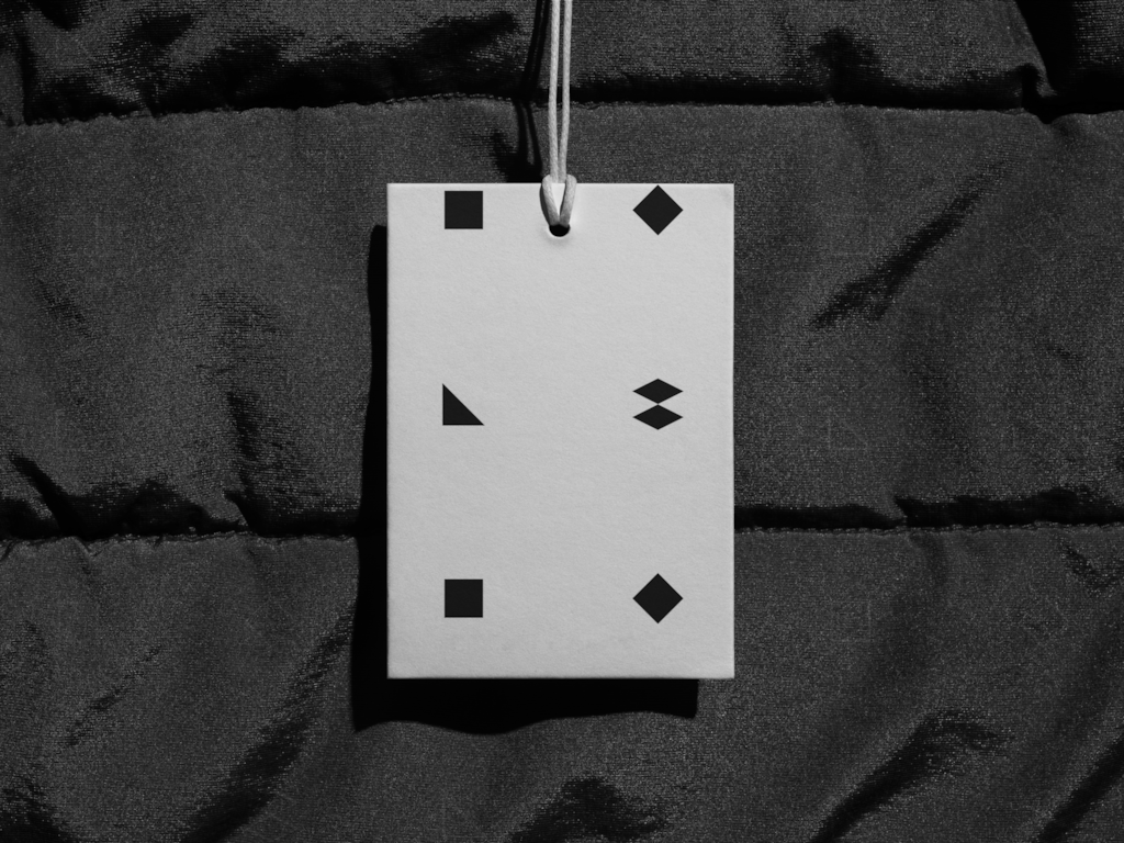 Tag 02 — On puffer jacket mockup surface