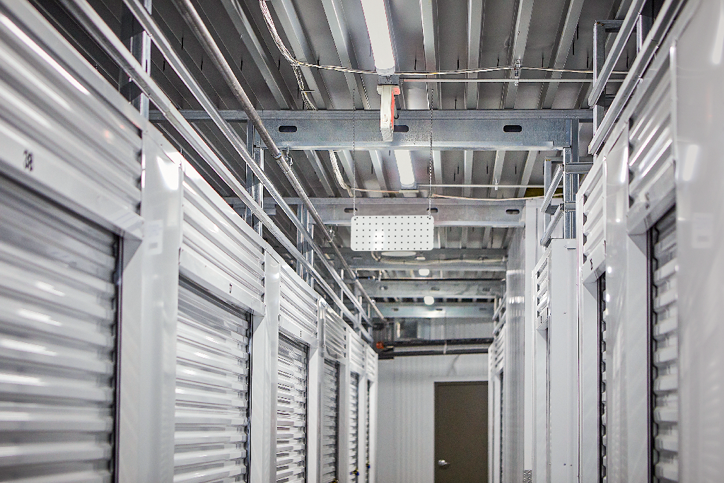 Sign 2277 — Hanging, in warehouse mockup surface