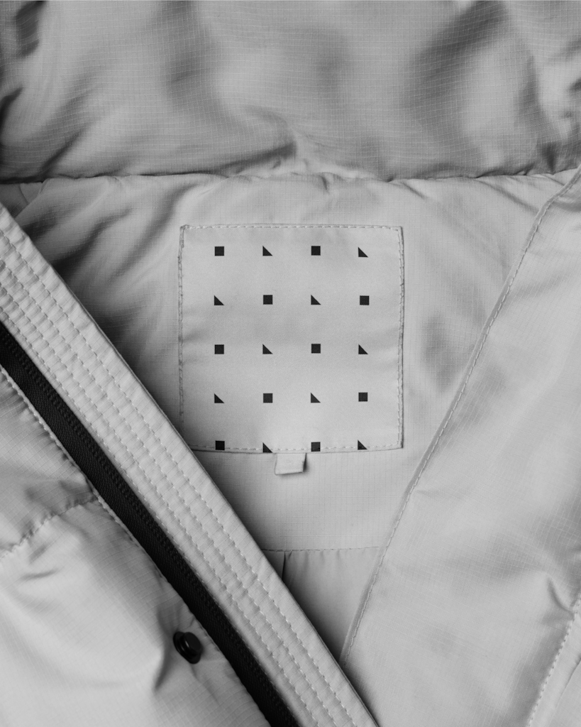 Label 02 — On puffer jacket mockup surface